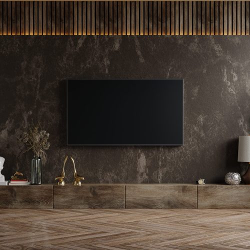 Mockup a TV wall mounted in a dark room with plant on dark marble wall background,3d rendering